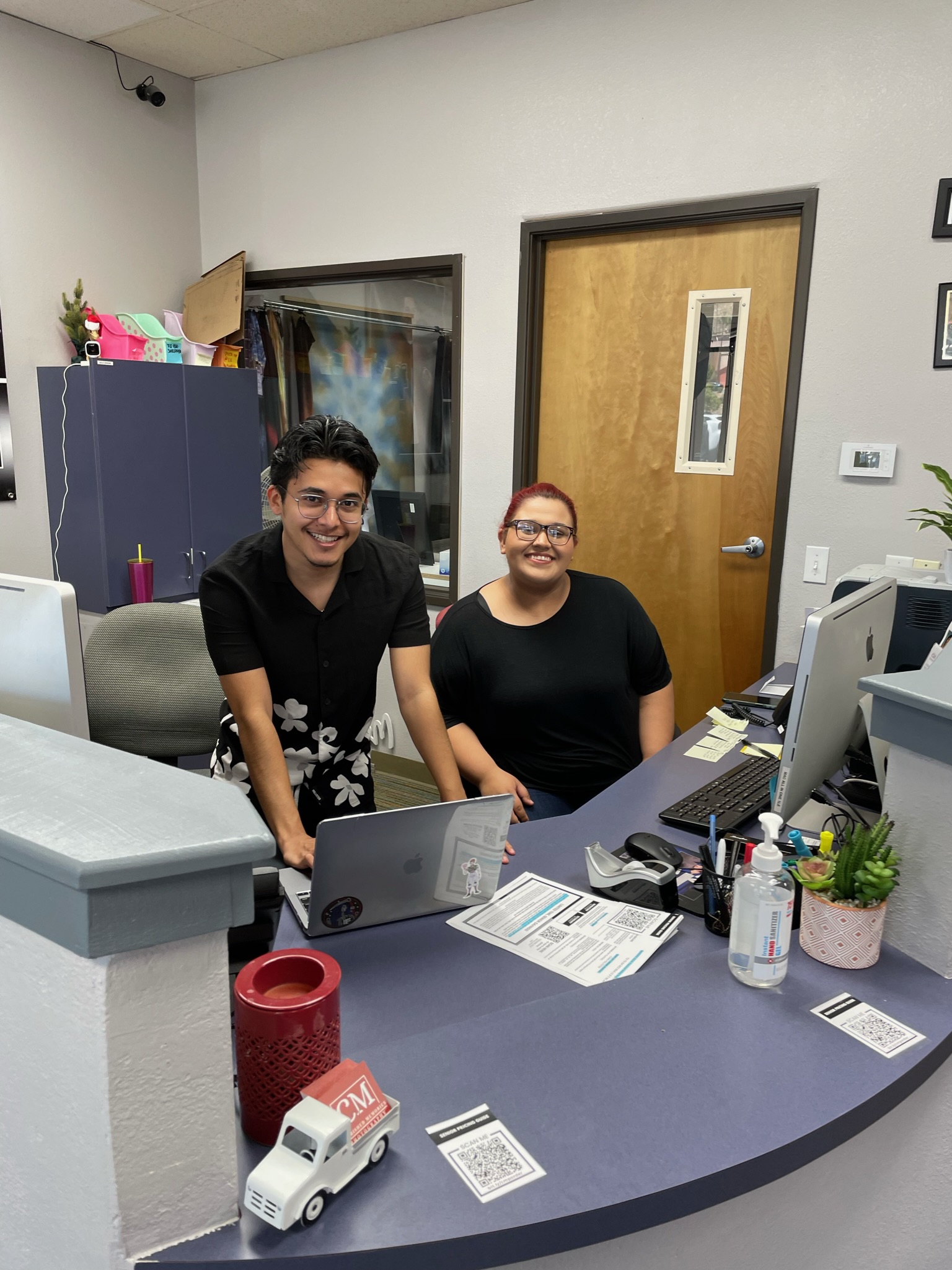 Cherished Memories team members at the studio front desk