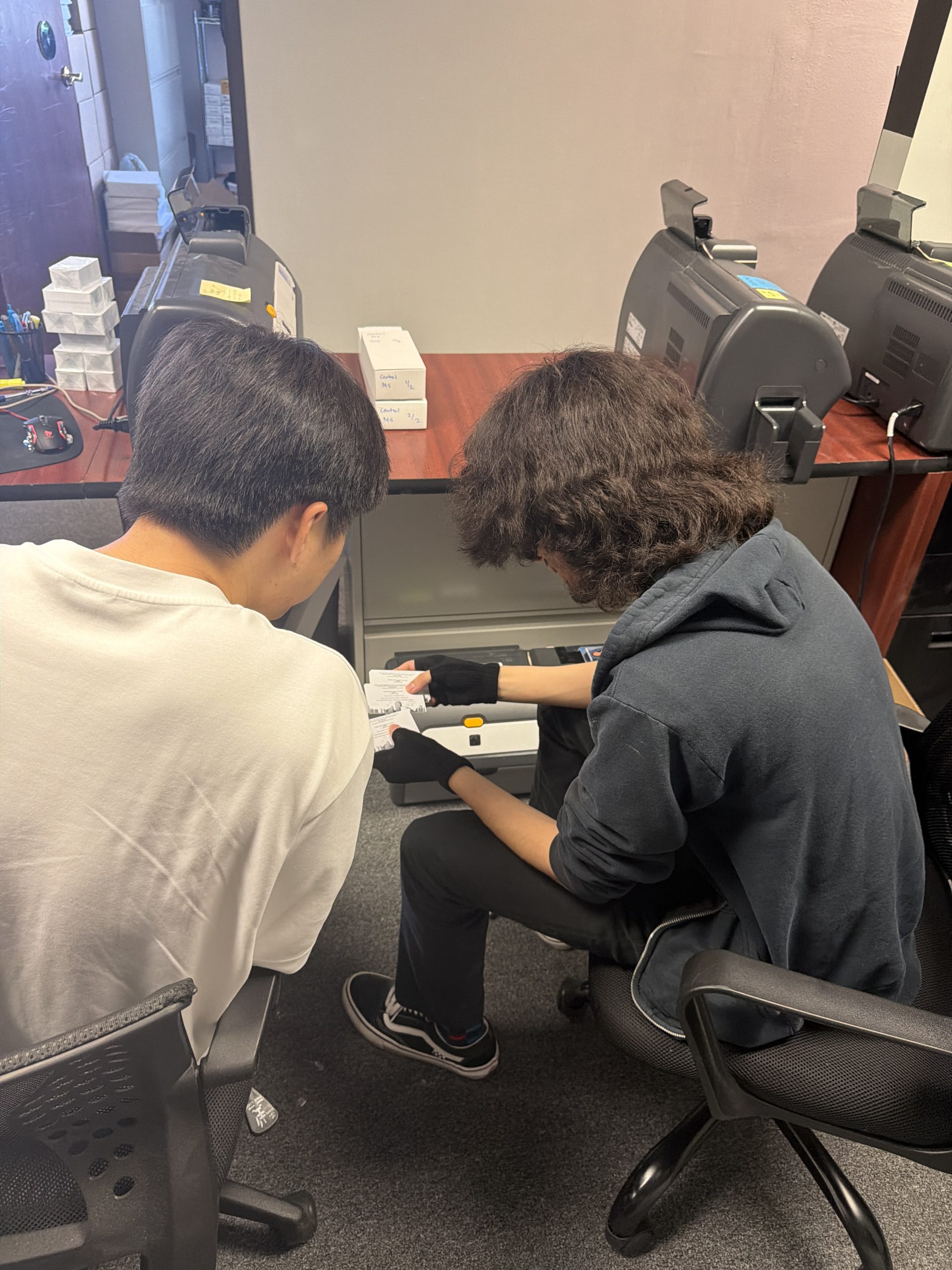 A Cherished Memories production team member preparing and processing photo orders