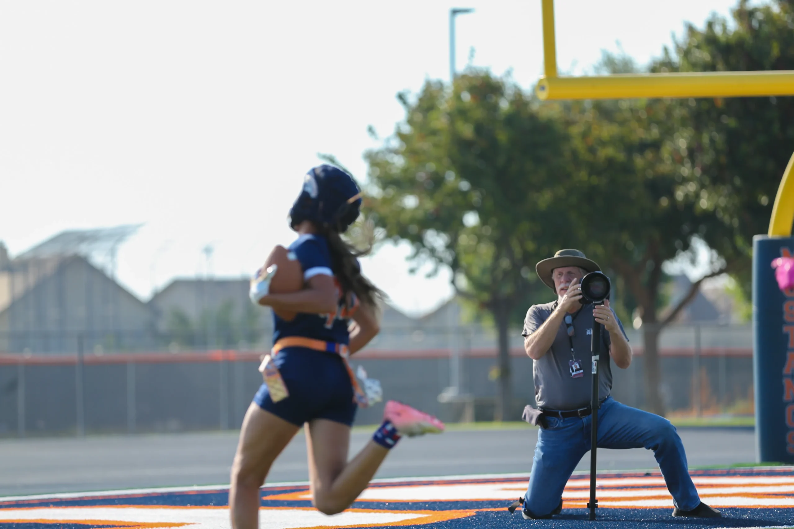 An ALSP sports photographer capturing a youth flag-football athlete on the field